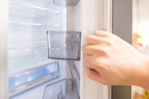 冷蔵庫に手を伸ばす
